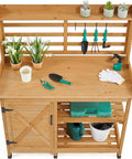 Large Outdoor Potting Bench With Storage Cabinet And Shelf Planting Console For Patio Lawn Garden Pro Grade Fir Wood Workstation Built To Last Durable Finish And Easy Assembly with tools and plants visible.