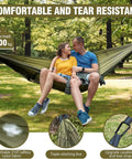 Couple relaxing in mosquito net camping hammock with lightweight parachute nylon, double or single setup, two tree straps