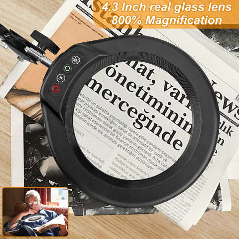 Big 8X Magnifying Glass With Light And Stand Clamp On LED Desk Lamp Arm over newspaper showing magnified text.