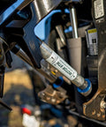 Close-up of Motor Stik Pair Heavy Duty 8.75 Inch Transom Saver For Outboard Trailering stabilizing trim rams on a boat engine