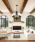 Affordable Luxury Five Light Farmhouse Chandelier In Classic Black Finish with clear glass shades in a living room setting