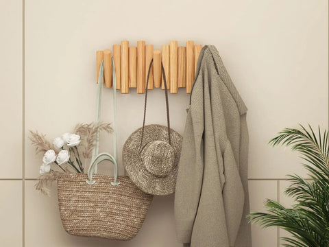 Foldable Wall Coat Rack With Five Hidden Hooks, Modern Wooden Wall Mount Coat Hanger holding bag, hat, and coat in entryway.