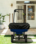 Built Tough Heavy Duty 600D Waterproof Broadcast Spreader Cover For 85-100 Lb seen on spreader in garden setting.