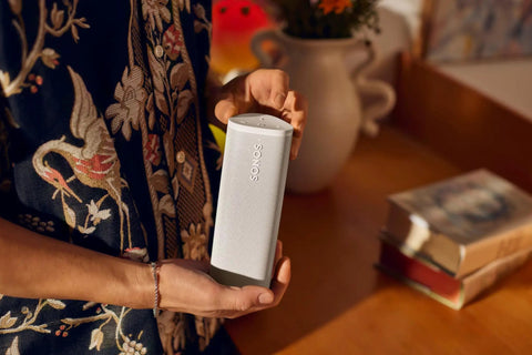 Person holding Roam 2 White Portable Waterproof Bluetooth Speaker With Crisp Clarity And Deep Bass, IP67 Durability, Ultra Compact