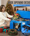Woman using Extra Large Moving Bags 4 Pack Heavy Duty Storage Totes With See Through Window And Wraparound Handles in holiday decor setting.