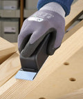 Pocket StickFix Hand Sanding Block with Quick Change Hook and Loop system used on wood, compact grip held by gloved hand.