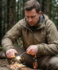 Man using Easy Fire Starter Rod With Compass for camping, magnesium ferrocerium fire spark rod striking sparks onto kindling outdoors.