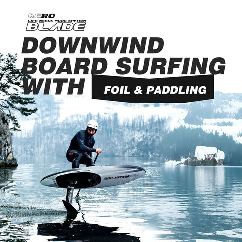 Man on Inflatable Downwind Surfing SUP 135L AeroBlade Edition with foil and paddle, gliding on water, surrounded by snowy landscape.