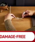Using Round Cord Clips For No Tool Cable Management Clear Damage Free Hanging Wall Clips on a wooden desk for cable organization.