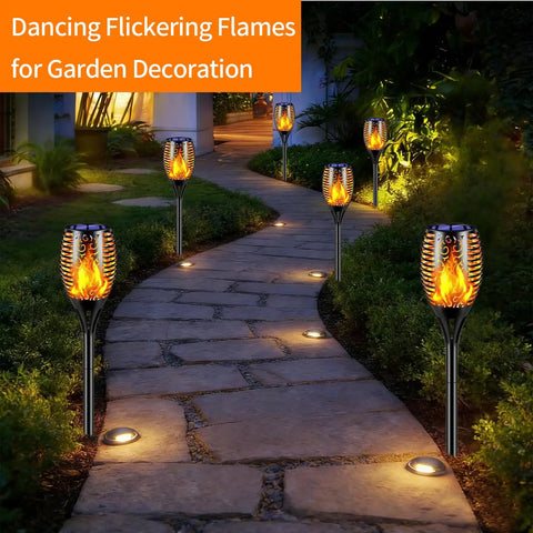 Six Pack Solar Torch Lights With Realistic Flickering Flame lighting a garden pathway at night, enhancing outdoor ambience.