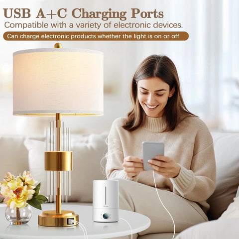 Dope Gold Table Lamp Set Of 2 With USB A And USB C Ports, Touch Control, on white table next to woman using phone