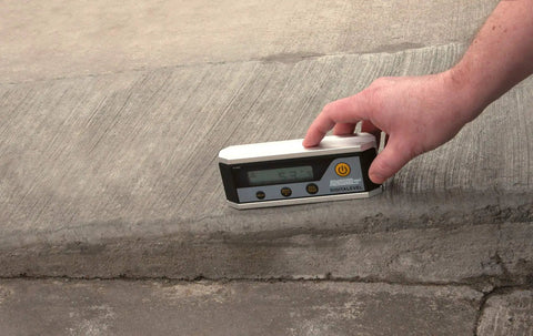 Person using 6 Inch Magnetic Digital Level with Auto Inversion for Overhead Readings on concrete surface, displaying measurement.
