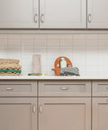 Modern kitchen setup with light cabinets and tile backsplash, featuring Solid 3 Inch Square Arch Cabinet Pulls In Matte Black 25 Pack Big Drawer Handles.