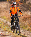 Cyclist on mountain trail in autumn with Two Pack Heavy Duty Bike Tubes 26x1.25 AV Schrader Valve Fits 26x1.0 26x1.25 26x1.50