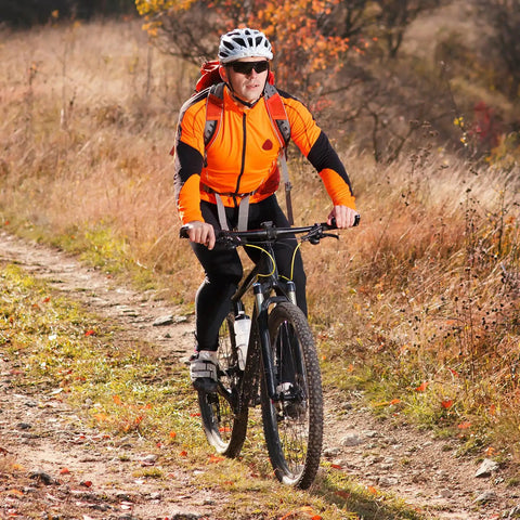 Cyclist on mountain trail in autumn with Two Pack Heavy Duty Bike Tubes 26x1.25 AV Schrader Valve Fits 26x1.0 26x1.25 26x1.50