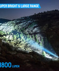 Ultra Bright 1800 Lumen LED Tactical Flashlight lighting up rocky terrain during nighttime, showcasing bright beam range