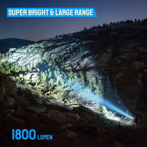 Ultra Bright 1800 Lumen LED Tactical Flashlight lighting up rocky terrain during nighttime, showcasing bright beam range