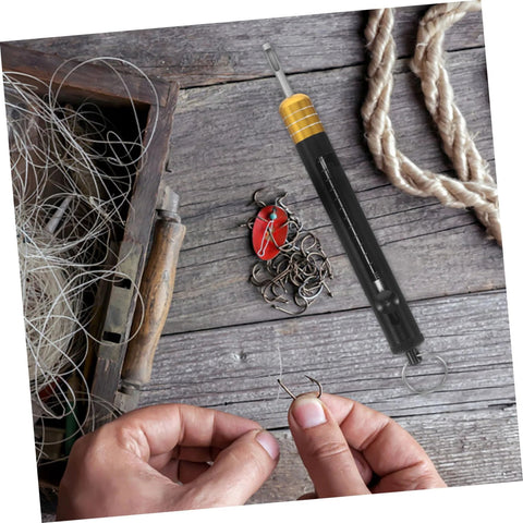 KICHOUSE stainless steel fishing hook detacher tool, black handle with yellow grip, near lures.