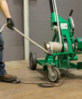 Greenlee 10k Tugger Package Featuring Dual Speed Motor For Faster Pulls, showing a user operating the mobile cable tugger.