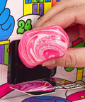 Hand holding a pink marbled squishy from the Squishmas Advent Calendar With 24 Days Of Hype NeeDoh Sensory Squishies.