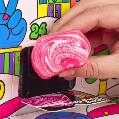 Hand holding a pink marbled squishy from the Squishmas Advent Calendar With 24 Days Of Hype NeeDoh Sensory Squishies.