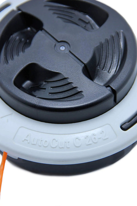 Close-up view of AutoCut C 26-2 Trimmer Head with Easy-Load Auto-Feed design, black and gray, for fast line replacement.