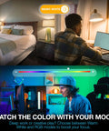 Man using laptop with Smart LED Bulbs 4 Pack With WiFi 2 4GHz and Bluetooth 5.0 in a bedroom and gaming setup.
