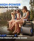 People by a lake using a Tailgater Boom Outdoor Portable Bluetooth Speaker With Mic In FM Radio USB Port Battery IPX5 Water Resistant Wireless Stereo Link App Control 60W Peak Power For Parties Karaoke Tailgating Travel And Family Gatherings, showing speaker size and design.