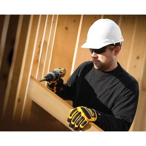 Worker wearing Polarized Safety Glasses With Z87.1 Rating Built For Grind-Ready Outdoor Work On The Job Site using a drill.