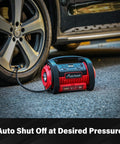 Portable Tire Inflator Air Compressor With Dual Motors, 12V DC And 110V AC, connected to a car tire on pavement