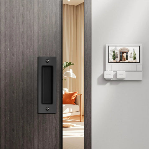 6 Inch Flush Pull Sliding Barn Door Handle Set on wooden door, recessed rectangular plate in matte black, installed, room background