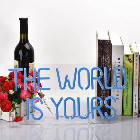 17 By 8 Inch LED Neon Blue The World Is Yours Dimmable Wall Sign with USB Power, shown beside books and flowers