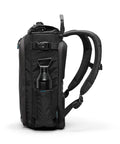 Side view of City Commuter Camera Backpack with 18 Liter Rolltop Closure, showing padded straps and water bottle pocket in rugged black.