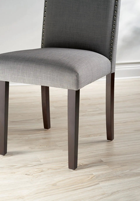 Top Shelf Felt Furniture Protectors For Hardwood Floors Beige Self Stick Pads under grey chair leg on light wood floor.