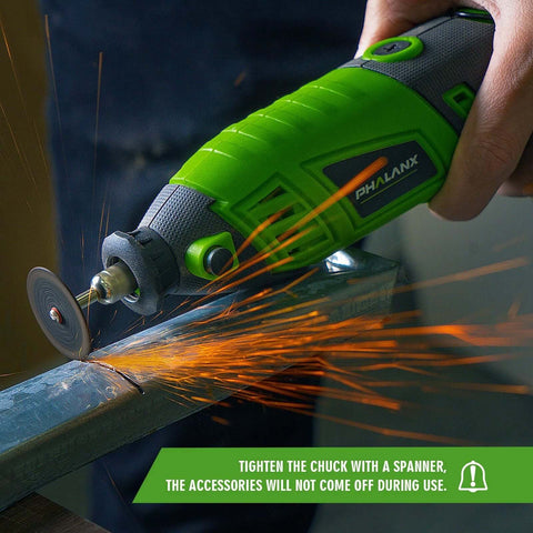Side view of green PHALANX rotary tool with grinding wheel, sparking on metal workpiece.
