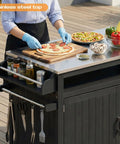 Person preparing food on 43.3-Inch Outdoor Kitchen Island With Storage Cabinet And Stainless Steel Top All-In-One Solid Wood Prep Station.