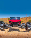 Front view of RC vehicle with Belted 2.8 Inch Sand Paw HP Paddle Tires On Raid Black 6x30 Wheels for sand drag racing.