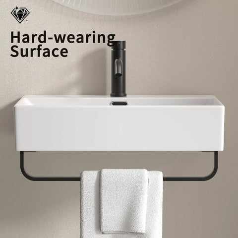 HAOCHRYSYPH Ceramic Wall Mount Sink with Towel Rack, Milk White, 23.63 in. with towel underneath on a smooth wall.