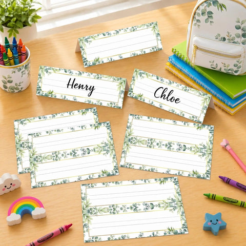 48 Pcs Tented Desk Nameplates Set For Students, 9 By 3 Inch Eucalyptus Style Reusable Name Tags on a classroom desk with crayons