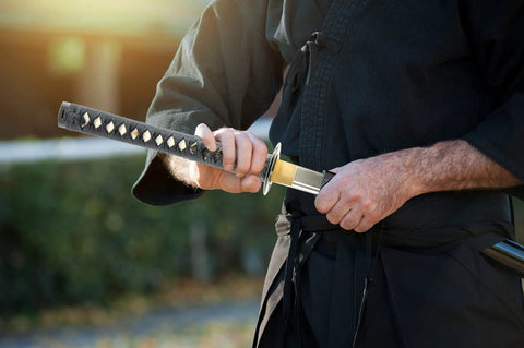 Person holding Kickass Unsharpened Aluminum Wakizashi Iaito For Iaido Practice 21 Inch Tomoe Crest Training Sword with Fuller Bo Hi.