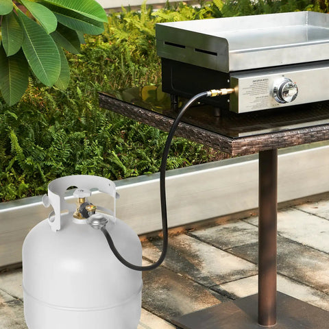Propane Hose Regulator With Gauge 3Ft Replacement Hose for Outdoor Grills connected to a propane tank and grill setup.