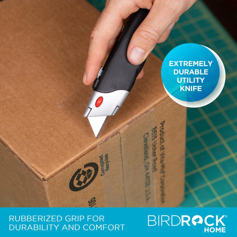 BirdRock Home retractable utility knife with black handle and rubberized grip cutting a cardboard box