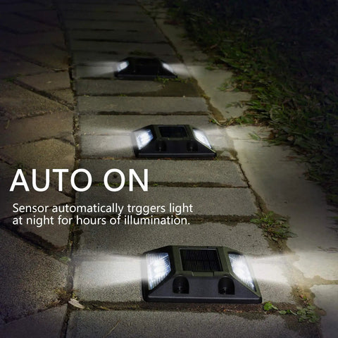Solar Powered LED Deck Lights 6 Pack For Walkways And Driveways glowing on stone path at night