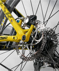 Close-up of rear bike wheel with Beefy 12mm Thru Axle For Front And Rear Bike Hubs Fits 123mm 142mm 162mm 168mm 171mm 175mm 177mm 181mm Lengths With M12x1.5 Thread Pitch Perfect For MTB Gravel Road E Bike And BMX Upgrades, showing CNC-machined axle.