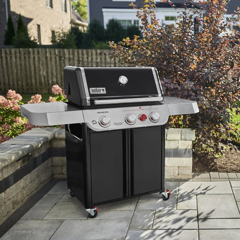 Genesis E 325 Liquid Propane Gas Grill For Outdoor Cooking With Three Burners Black Porcelain Enameled Cast Iron Grates PureBlu Burners And Sear Zone To Level Up Your Grill Game And Extra Grilling Space on patio