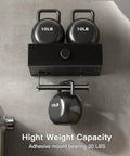 Black Toilet Paper Holder With Shelf And Drawer Storage, holding 10lb weights to demonstrate strength and adhesive mount capacity.