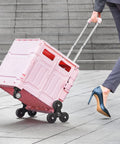 Person using Foldable Utility Cart 65L Portable Crate Rolling Cart With Stair Climbing Wheels And 360 Degree Swivel Wheels Telescoping Handle.