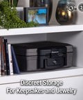 Fireproof And Waterproof Portable Safe Lock Box With Key Lock And Carrying Handle For Money Passport And Valuables Exterior Size 14.3 In W 13 In D 6.1 In H Travel Ready placed on a shelf among books.