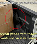 Secured cardboard box with cable in pickup truck bed, highlighting prevention of shaking in motion.