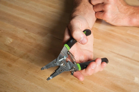 Hand holding Stainless Steel Wire Stripper For 10-18 AWG Solid And 12-20 AWG Stranded, Heavy Duty Stripper Cutter And Crimper Tool